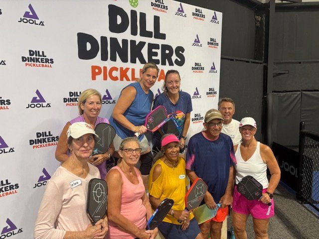 A camp group holding their paddles after a session